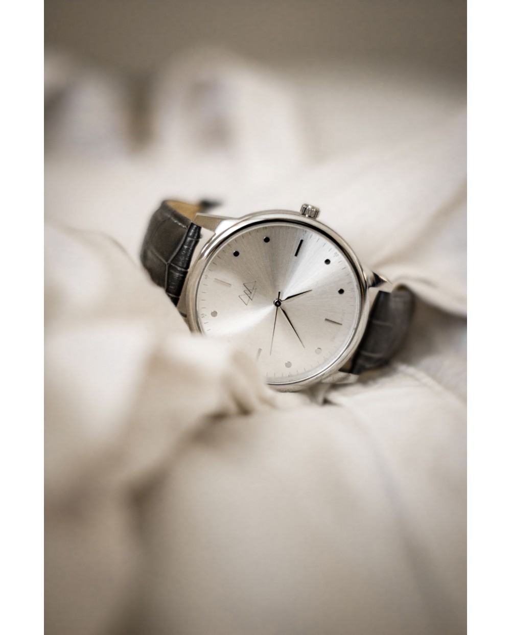 silver dial with black strap watch